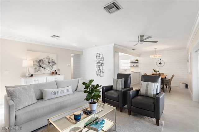 living room with ceiling fan and ornamental molding