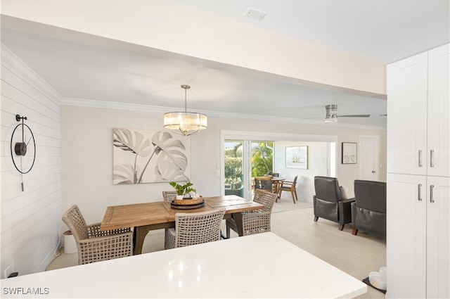 dining area featuring ceiling fan with notable chandelier and ornamental molding