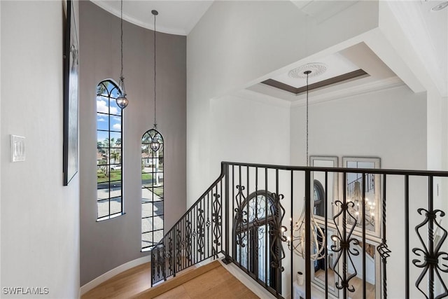12611 Apopka Ct, North Fort Myers, FL 33903 - stairway with plenty of natural light, a chandelier, baseboards, crown molding, and a high ceiling