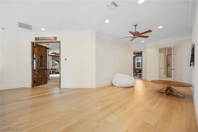 interior space with ceiling fan, crown molding, and light hardwood / wood-style floors