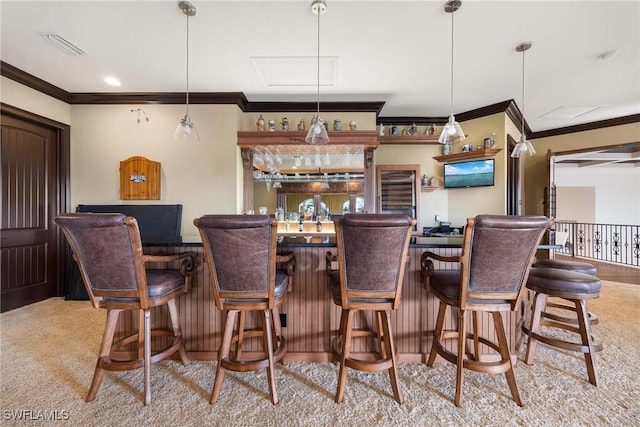 bar featuring decorative light fixtures, ornamental molding, and light colored carpet