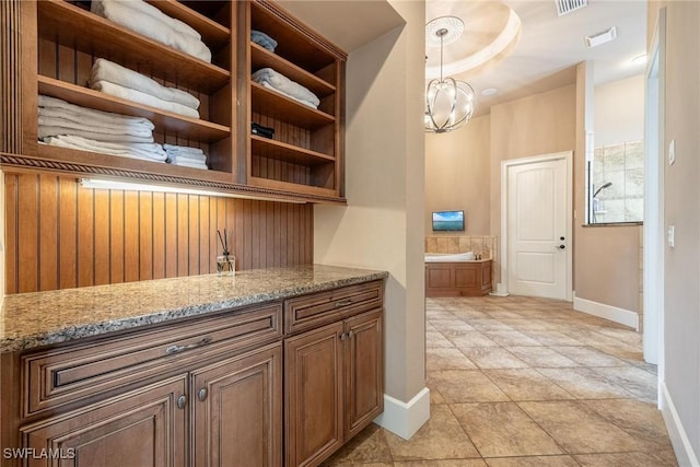 12611 Apopka Ct, North Fort Myers, FL 33903 - bar featuring baseboards, decorative light fixtures, light tile patterned floors, and a chandelier