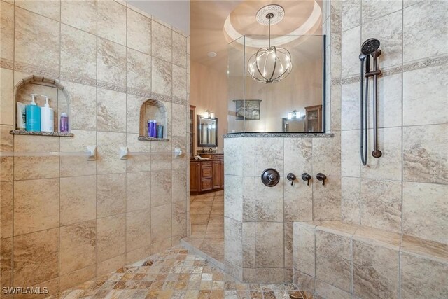 12611 Apopka Ct, North Fort Myers, FL 33903 - bathroom featuring tiled shower, vanity, and a chandelier