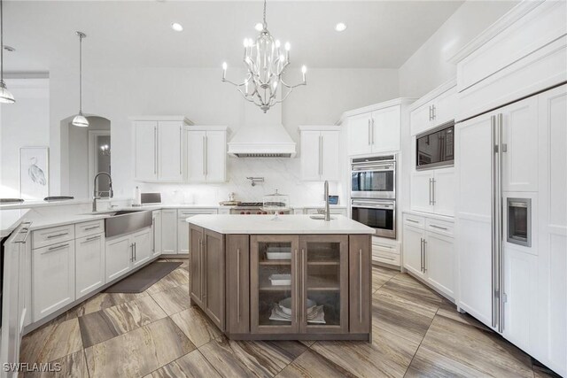 kitchen featuring custom exhaust hood, backsplash, double wall oven, decorative light fixtures, and black microwave