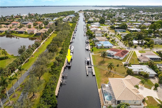 birds eye view of property with a water view