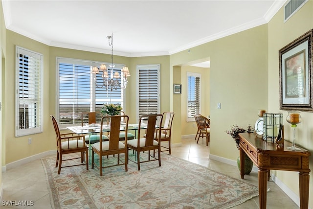 dining area featuring light tile patterned floors, crown molding, and a chandelier