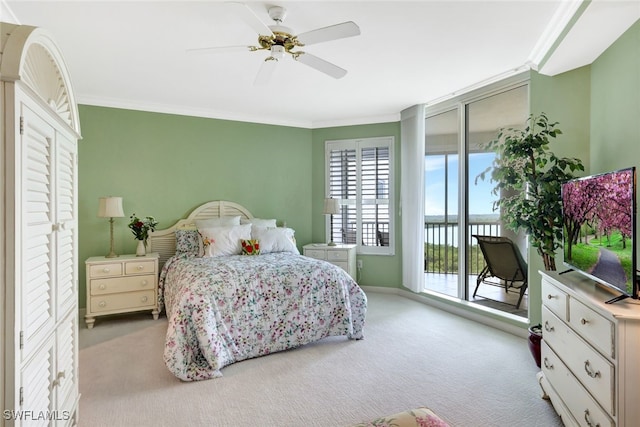 carpeted bedroom featuring access to outside, ceiling fan, and crown molding