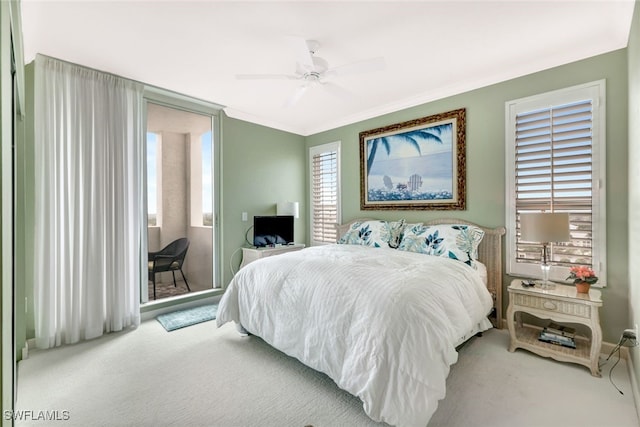 carpeted bedroom featuring ceiling fan and ornamental molding