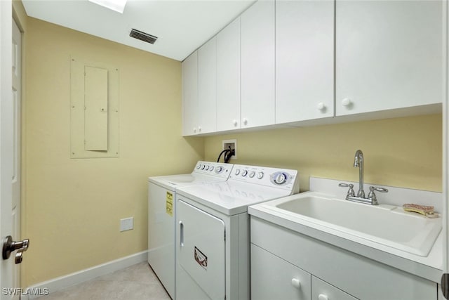 laundry room with cabinets, sink, independent washer and dryer, electric panel, and light tile patterned flooring