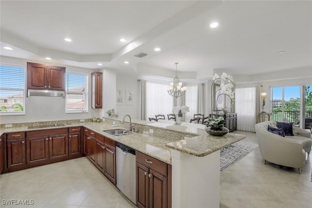 580 El Camino Real Unit 3201, Naples, FL 34119 - kitchen with dishwasher, a peninsula, a raised ceiling, a chandelier, and a breakfast bar