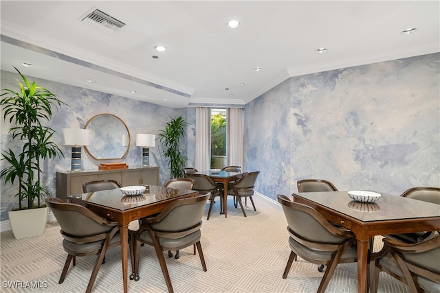 dining space featuring crown molding