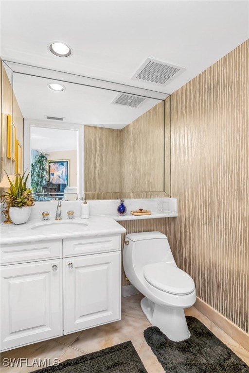 bathroom featuring tile patterned floors, vanity, and toilet