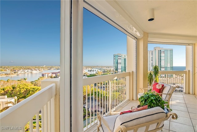 sunroom featuring a water view and a wealth of natural light