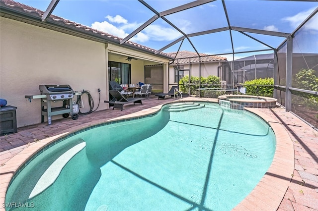 view of pool featuring glass enclosure, ceiling fan, an in ground hot tub, a grill, and a patio area