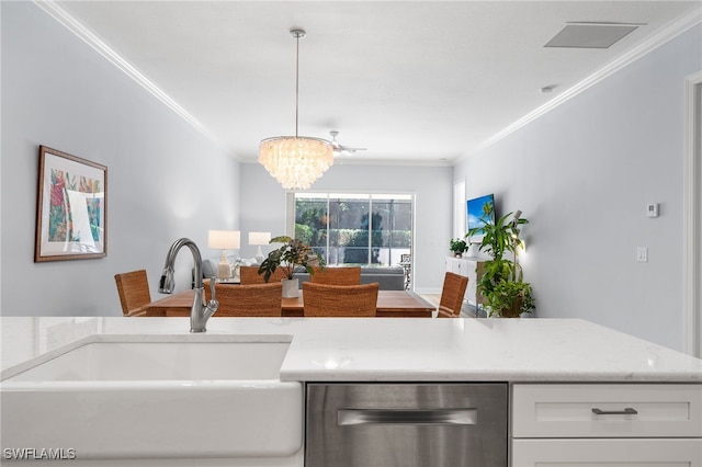 kitchen featuring white cabinetry, sink, a notable chandelier, decorative light fixtures, and ornamental molding