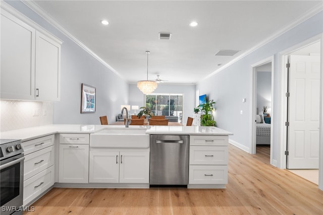 kitchen with white cabinets, range, stainless steel dishwasher, and sink