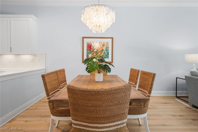 dining area with light hardwood / wood-style flooring and a notable chandelier