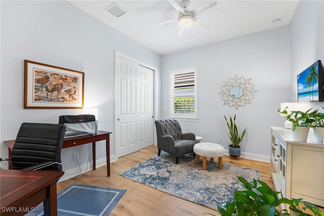 living area with light wood-type flooring and ceiling fan