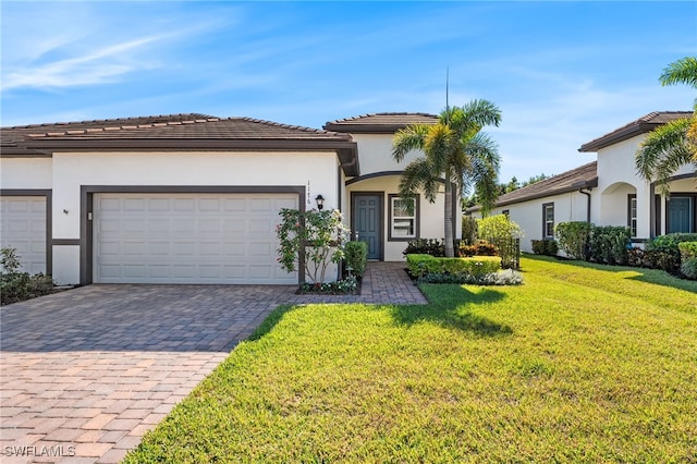 view of front facade featuring a front lawn and a garage