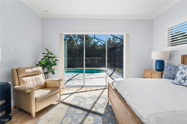 bedroom featuring access to outside, ornamental molding, and hardwood / wood-style flooring