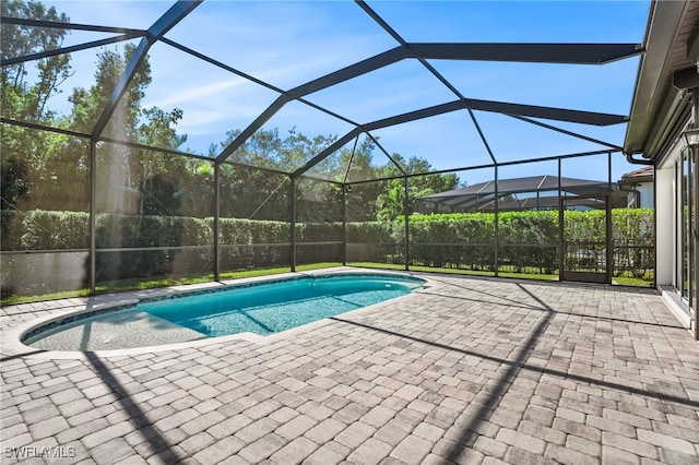 view of pool with a lanai and a patio