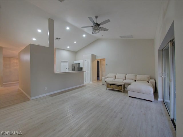 living room featuring ceiling fan, high vaulted ceiling, and light hardwood / wood-style floors