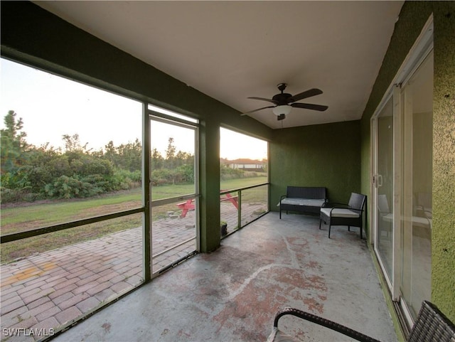 sunroom featuring ceiling fan