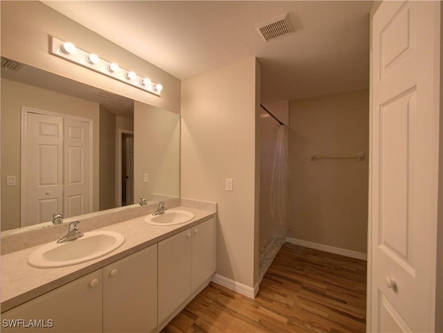 bathroom featuring vanity and hardwood / wood-style flooring