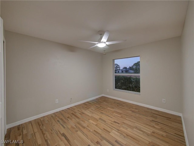 empty room featuring ceiling fan and light hardwood / wood-style floors