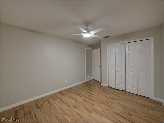 unfurnished bedroom with a closet, ceiling fan, and light hardwood / wood-style flooring