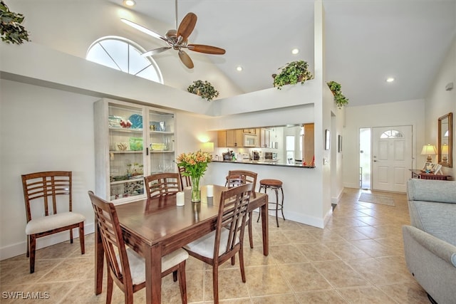 dining space featuring high vaulted ceiling, ceiling fan, and light tile patterned floors