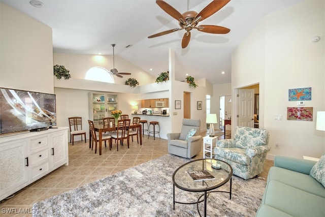 tiled living room featuring high vaulted ceiling and ceiling fan