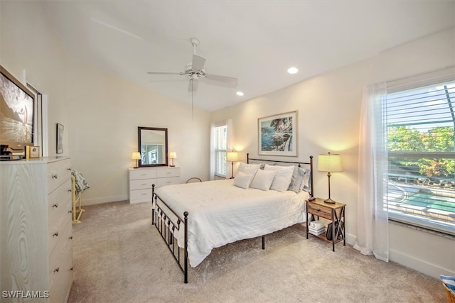 carpeted bedroom featuring lofted ceiling and ceiling fan