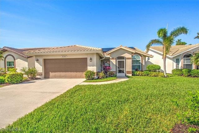 mediterranean / spanish-style home featuring a front lawn and a garage