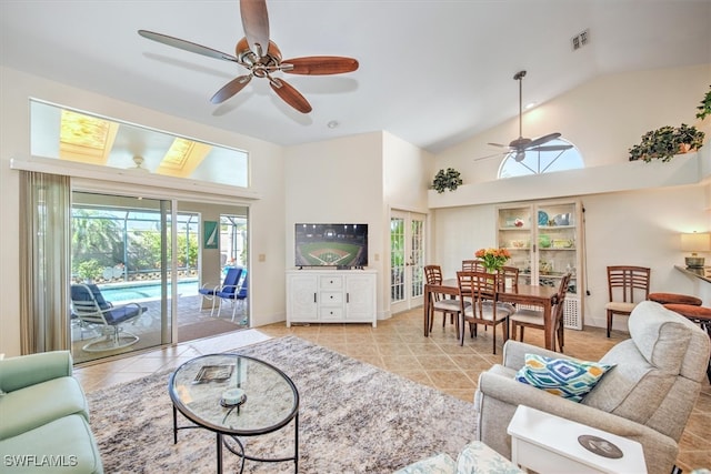 living room with high vaulted ceiling, ceiling fan, and light tile patterned flooring