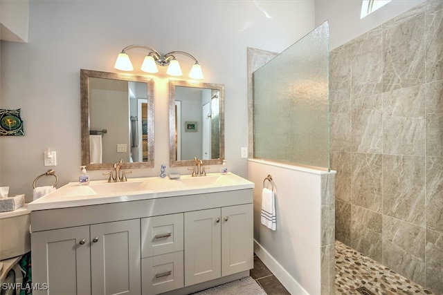 bathroom featuring vanity, tiled shower, and tile patterned floors