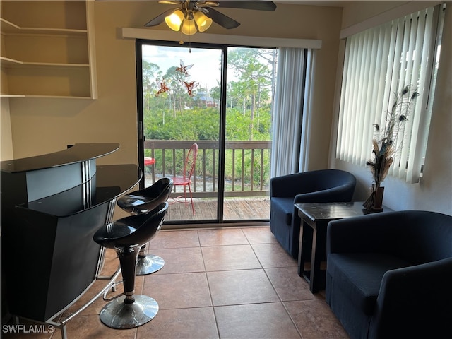 living room featuring ceiling fan and light tile patterned floors