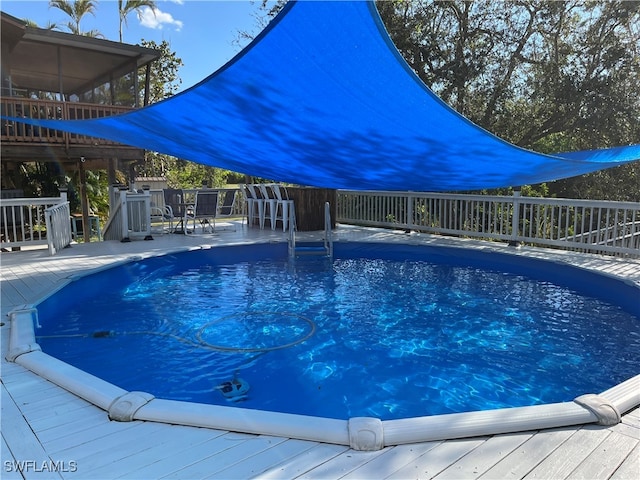 view of swimming pool with a deck