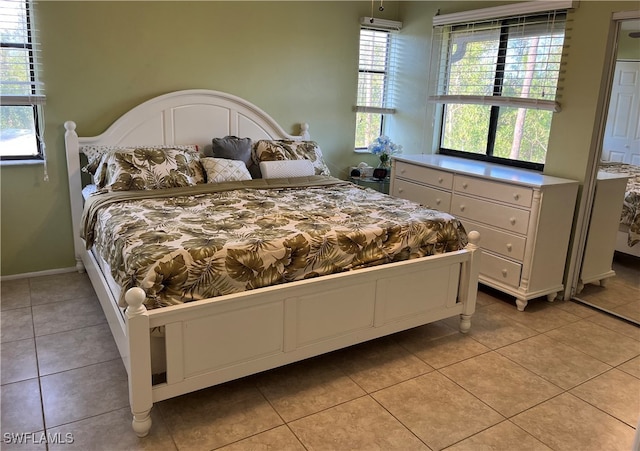 tiled bedroom with multiple windows