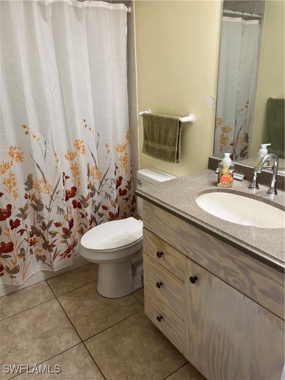 bathroom featuring toilet, vanity, and tile patterned floors