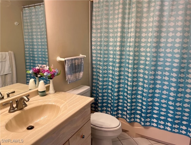 bathroom with tile patterned floors, vanity, walk in shower, and toilet