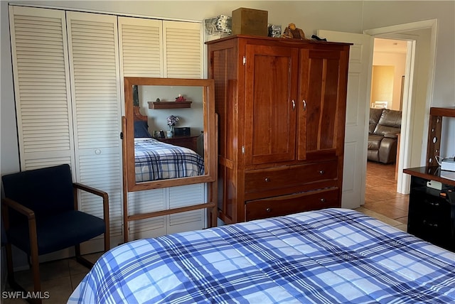 tiled bedroom featuring a closet