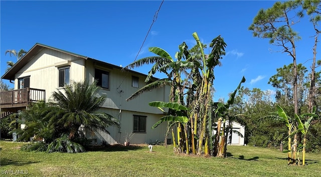 view of property exterior featuring a deck and a yard