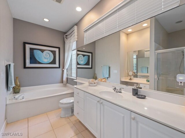 full bathroom featuring toilet, vanity, tile patterned floors, and independent shower and bath