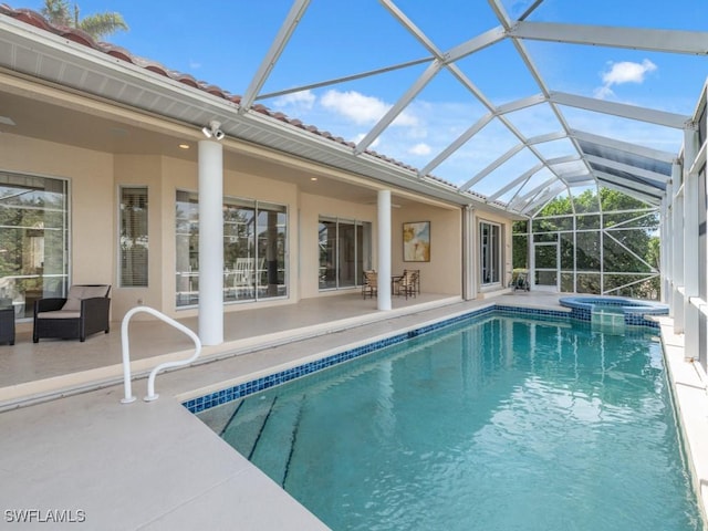 view of swimming pool with a patio and a pool with connected hot tub