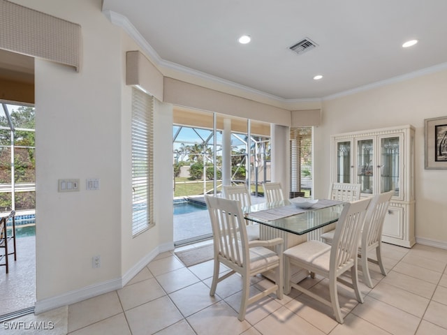 tiled dining area with a wealth of natural light and ornamental molding