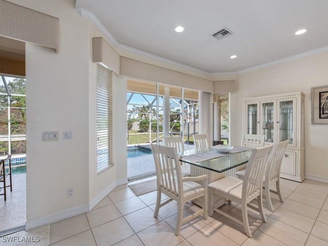 dining space with a sunroom, ornamental molding, visible vents, and baseboards