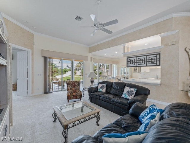 living room with baseboards, carpet flooring, visible vents, and crown molding