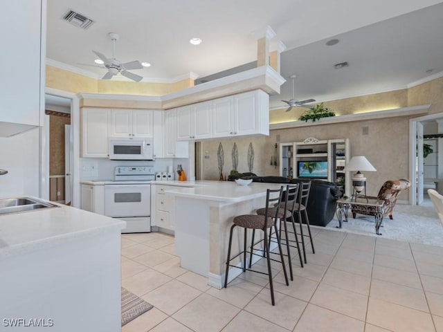 kitchen with ornamental molding, ceiling fan, white appliances, and visible vents