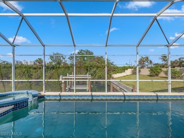 view of pool featuring an in ground hot tub and a lanai